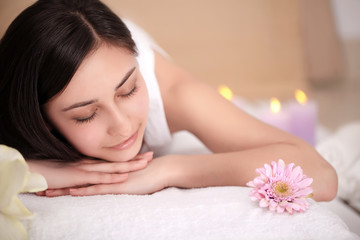Obraz na płótnie Canvas health, beauty, resort and relaxation concept - beautiful woman with closed eyes in spa salon getting massage
