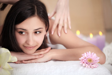 Fototapeta na wymiar Spa Treatment. Beautiful Woman Getting Stones Massage in Spa Salon.