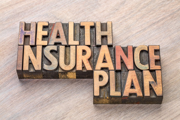 health insurance plan word abstract in wood type