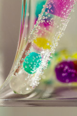 Abstract composition with underwater tubes with colorful jelly balls inside and bubbles
