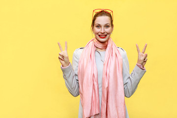 Young beautiful redhead woman showing peace sign.