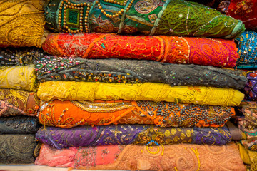 Close up of Indian Traditional Women Sari clothing on Market. Buying Wedding Sari in Jaipur. Colorful Beautiful Sari Dresses in the Store. Luxury Oriental Handmade Eastern Fabric