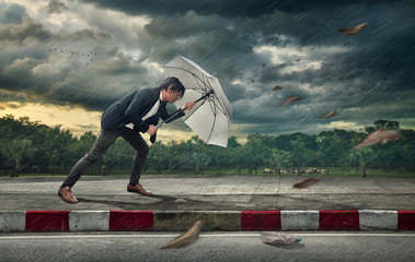 Businessman with white umbrella protecting himself from the storm.  Business heavy tasks and...