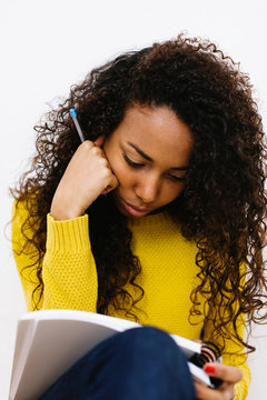 Young university woman studying hard at home.