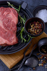 Raw beef steak, rosemary and spices in bowl