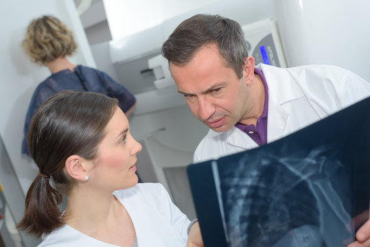 radiologist woman checking x ray with doctor