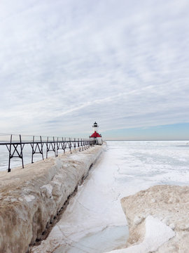 Vertical image of a Lake Michigan lighthouse in winter