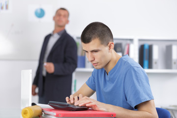 male student in classroom working