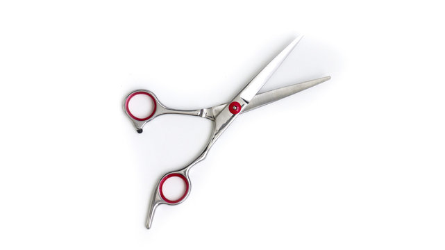 Stylish professional hairdressing scissors, hair cut on a white background. A hair salon concept hair salon. Haircut accessories. The image copy space