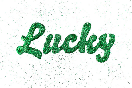 The word "lucky" spelled with green glitter