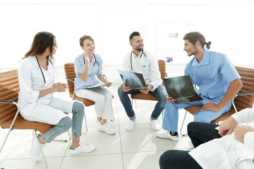 doctors discuss an x-ray ,sitting in the office.