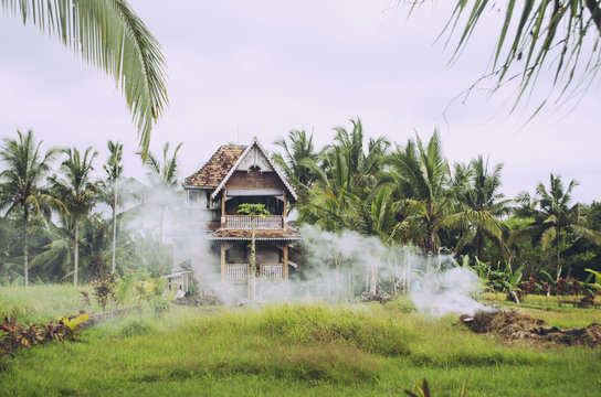 Smoke drifting across Balinese home