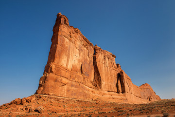 Arches National Park: The Tower of Babel (majestic sandstone formation with copy space on blue sky)