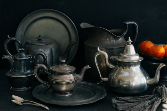 A set of pewter plates, platters, and pots.