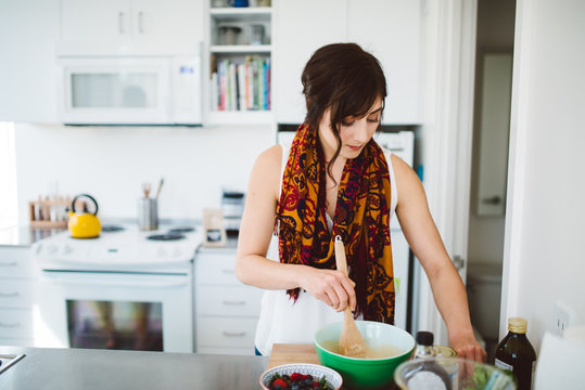 Young woman baking in her kitchen - Powered by Adobe