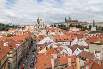 Naklejka na ściany i meble View of old buildings from above, St. Nicholas Church and Prague (Hradcany) Castle at the Mala Strana District (Lesser Town) in Prague, Czech Republic.