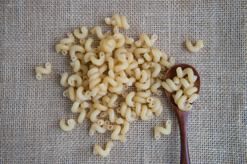 Cavatappi raw pasta on rustic background . Natural and healthy food concept.