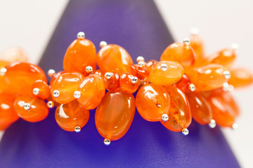 Silver jewels with colorful precious stones and light grey background
