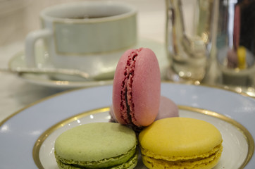 sweet and colourful french macaroons with tea cup