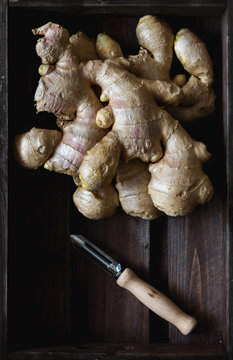 Ginger and peeler in wooden crate