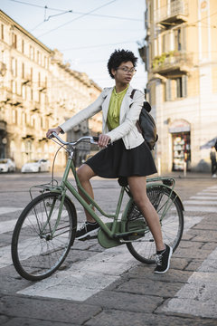 Young black woman portrait on a bicycle in the city