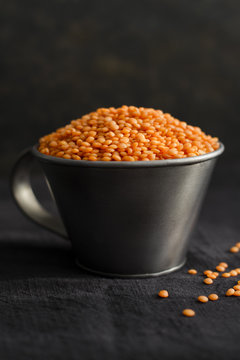Red lentils in a measuring cup