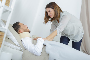 woman caring for sick boyfriend on bed