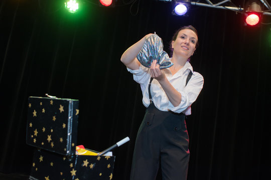 young beautiful magician on stage during show