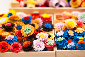 Fototapeta na wymiar Small, colorful paper flowers made with quilling technique 