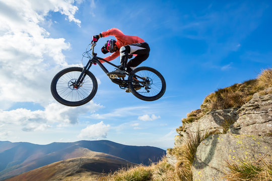 Professional rider is jumping on the bicycle.