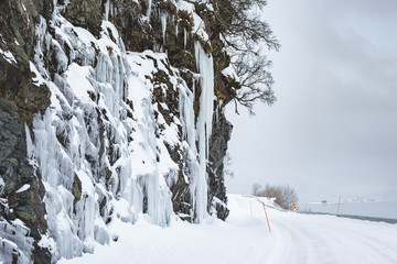 Dangerous large ice mirrors near a snowy road