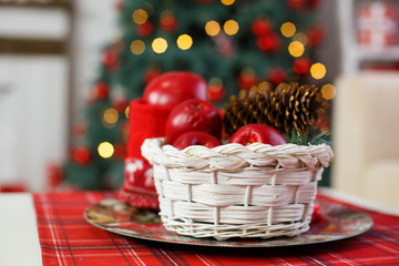 A basket with sweets for celebrating New Year. Decorative details of Christmas holiday. Beautiful interior with elegant accents. 