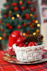 A basket with sweets for celebrating New Year. Decorative details of Christmas holiday. Beautiful interior with elegant accents. 