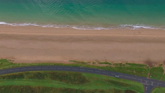 Car Driving on Scenic Ocean Highway, Aerial Drone Footage, Sandy Beach & Blue Waves