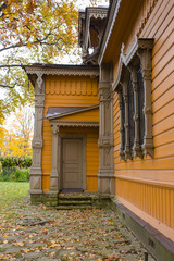 Fototapeta premium Wooden porch, door, entrance to the Russian traditional wooden house in autumn