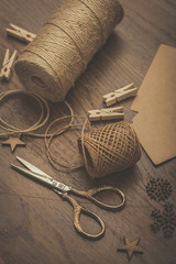 Christmas. Vintage style scissors and gift boxes on a rustic wooden table