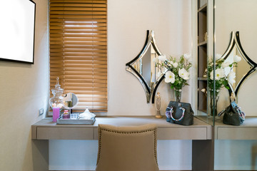 Modern closet room with make-up vanity table, mirror and cosmetics product in flat style house.