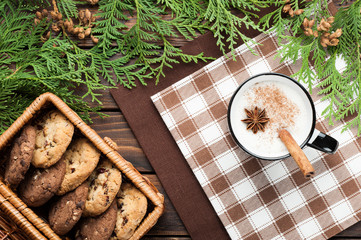 eggnog cocktail in  mug arranged with christmas decoration and cookies box on wooden table