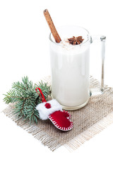 eggnog cocktail in glass arranged with christmas decoration isolated on white background