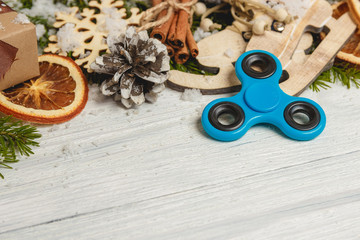 Spinner on white wooden table with christmas decoration