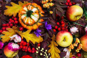 Naklejka na ściany i meble Thanksgiving arrangement with decorative pumpkin, apples, fall rowan leaves, top view