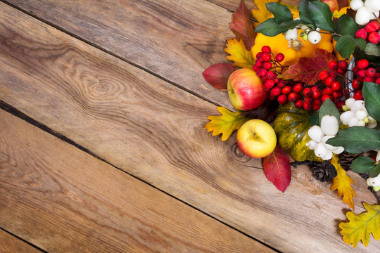 Fall background with snowberry, rowan, apples, leaves and squash, copy space