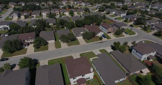 A daytime aerial establishing shot of a typical San Antonio, Texas residential neighborhood.  	