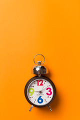 Round vintage clock on orange background.