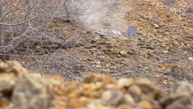 man is practicing shooting at targets from a shotgun