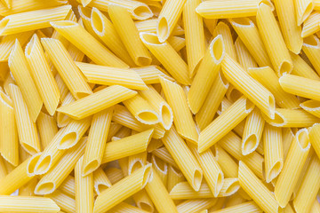 Colorful food background of penne rigate pasta