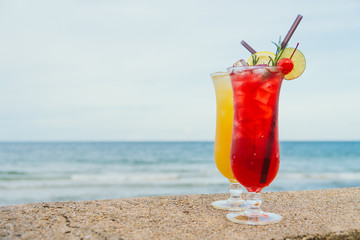 Iced cocktails drinking glass with beach and sea