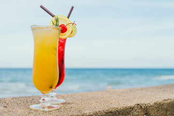 Iced cocktails drinking glass with beach and sea