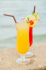 Iced cocktails drinking glass with beach and sea