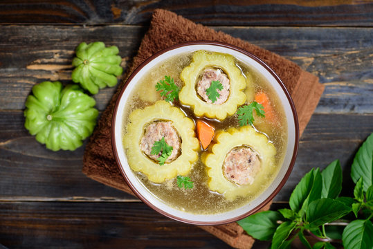 Thai food,bitter gourd soup with pork in a bowl on wooden background.Top view of food